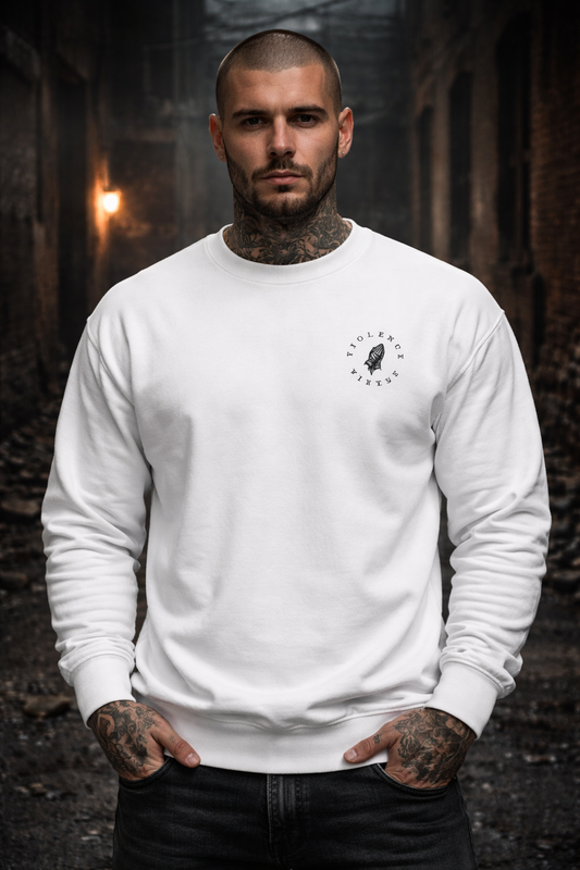 Man wearing a white sweatshirt with a logo in a dark, forest-like setting