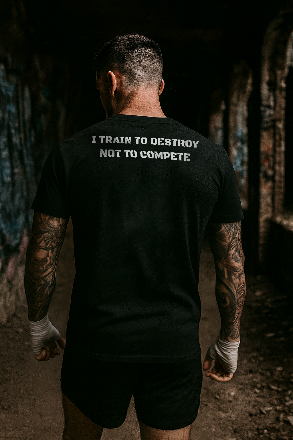 Person wearing a black t-shirt with text in an urban setting