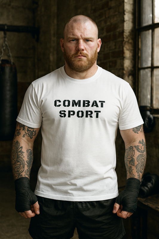 Man wearing a white 'COMBAT SPORT' t-shirt in a gym setting