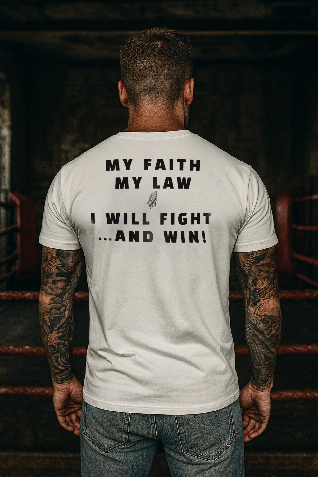 Man wearing a white t-shirt with motivational text in a dark indoor setting