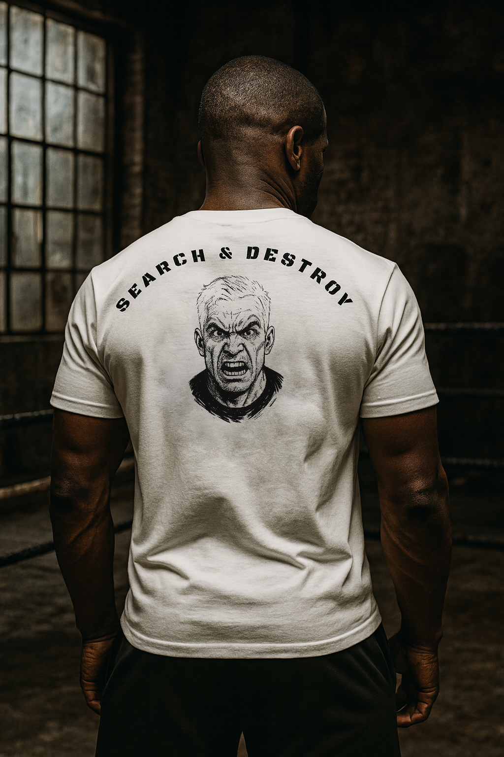 Person wearing a white t-shirt with 'Search & Destroy' graphic on the back in a dimly lit room.
