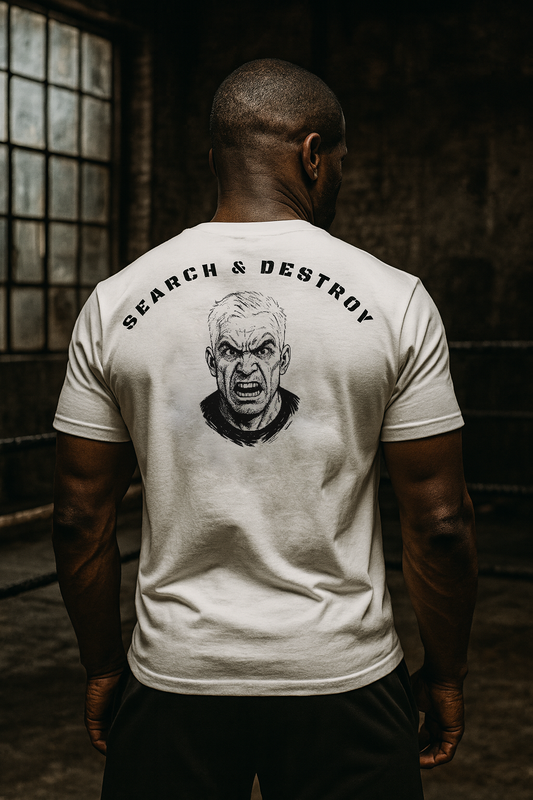 Person wearing a white t-shirt with 'Search & Destroy' graphic on the back in a dimly lit room.